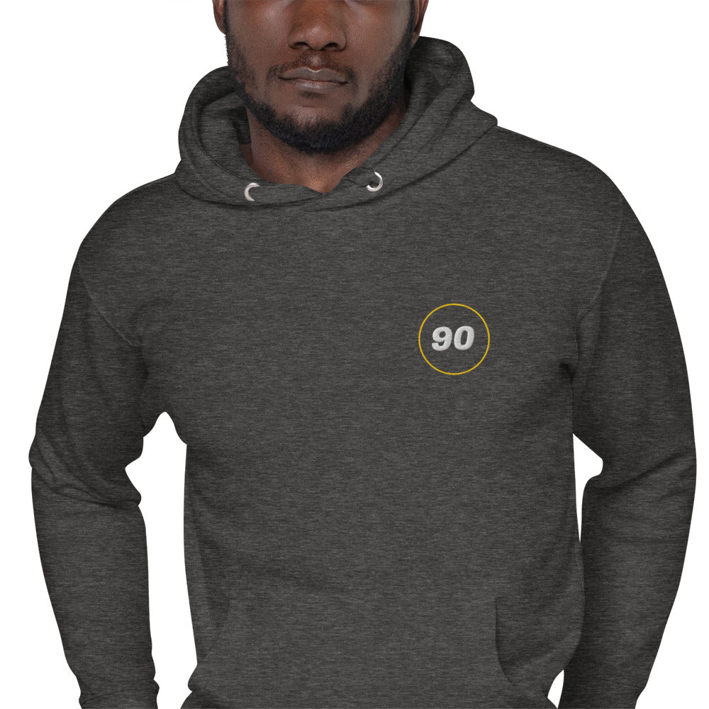 Man wearing a dark gray hoodie with a logo on the chest against a white background | colour:charcoal